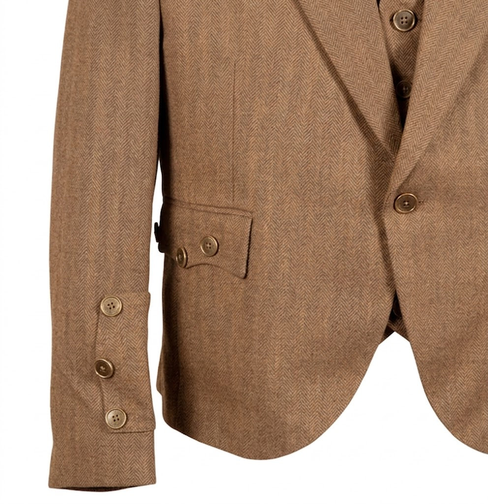 Close-up of premium tweed wool texture on men’s kilt jacket showing high-quality woven pattern