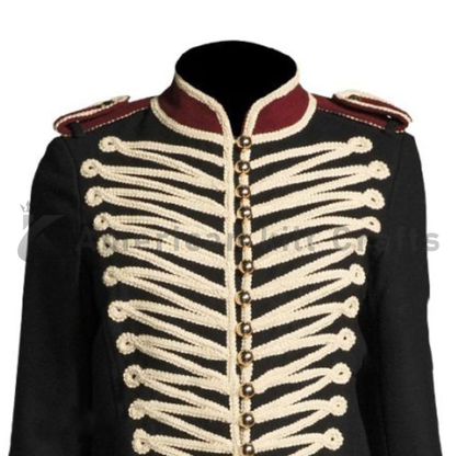 Close-up of decorative braiding, buttons, and wool twill fabric on a men’s black Hussar military marching band jacket.
