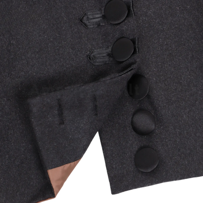 Close-up of a men's 18th century royal prince coat highlighting the ornate trim, buttons, fabric texture, stitching and luxury military-inspired craftsmanship.