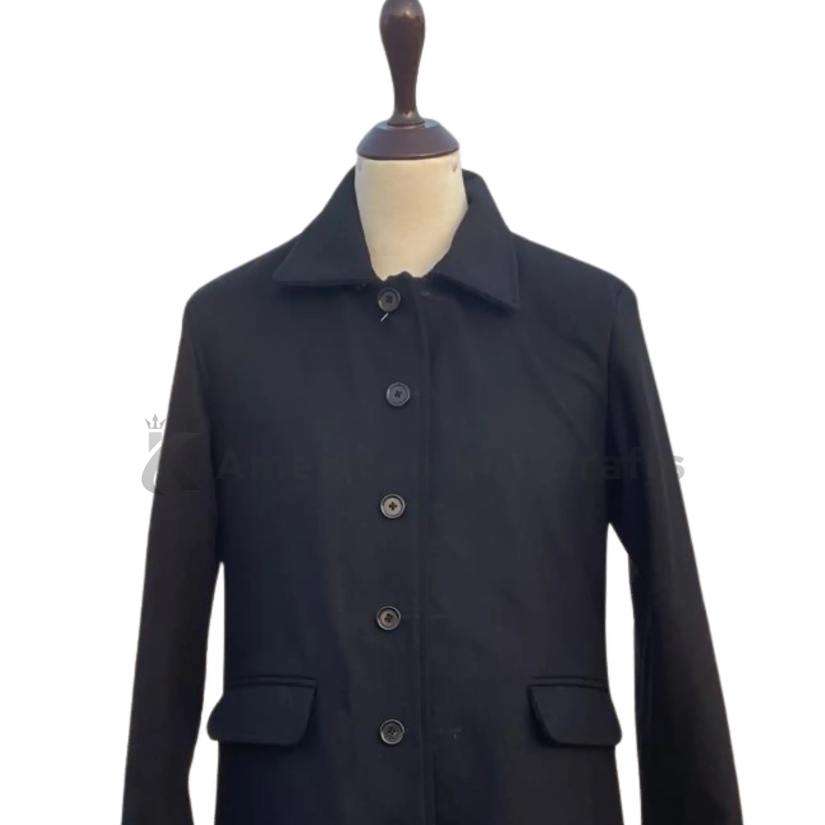 Close-up of a men’s black wool Inverness cape coat highlighting the wool texture, cape layering, buttons, stitching and Victorian-inspired tailoring details.