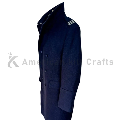 Side view of men’s blue wool long coat showing the structured fit, long silhouette, and classic double-breasted military overcoat style.