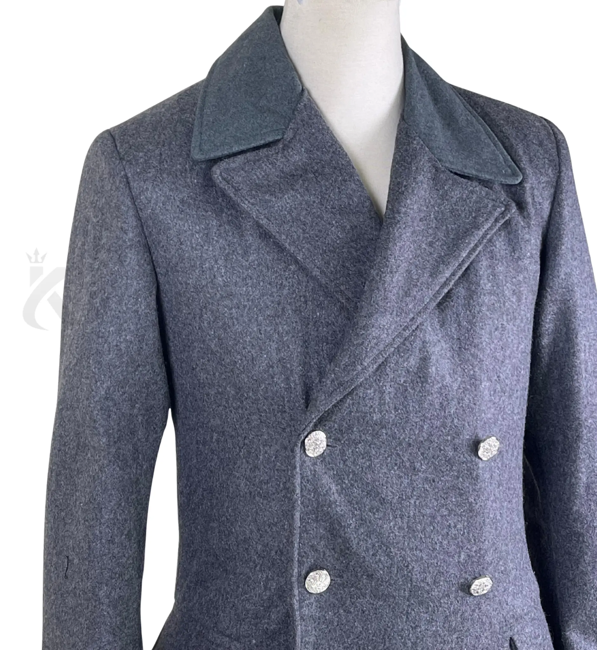 Close-up of men’s grey wool military greatcoat showing the double-breasted buttons, structured collar, wool texture and military-inspired detailing.