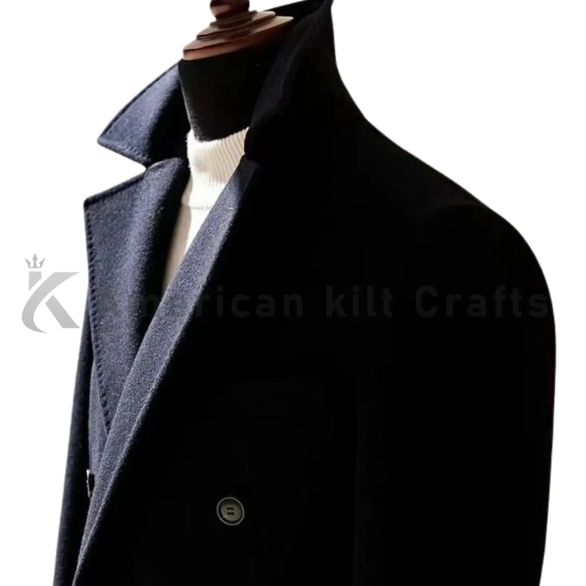 Close-up of men’s black double-breasted overcoat showing the wool fabric, lapel, buttons, stitching, and tailored craftsmanship.