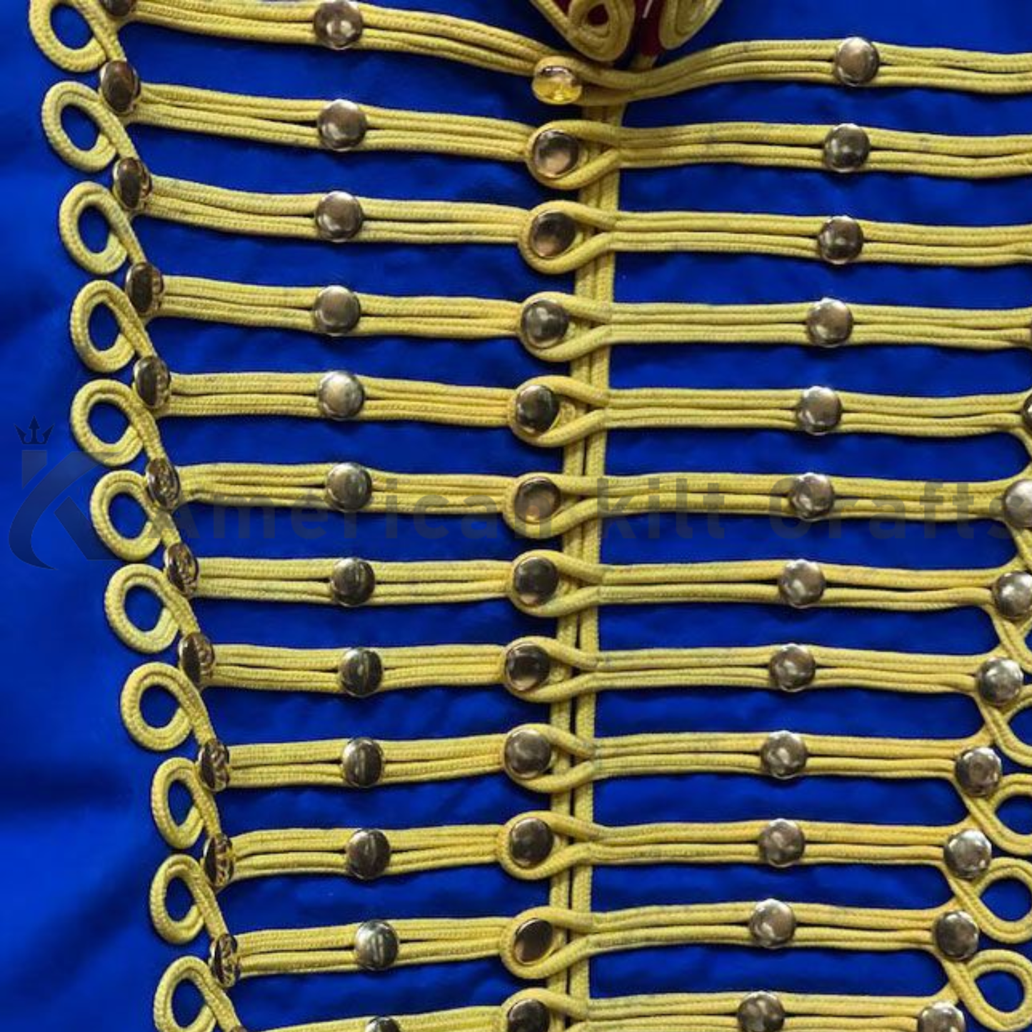 Close-up of men’s royal blue Hussars jacket showing the decorative braid, buttons, collar details, and wool-blend fabric.