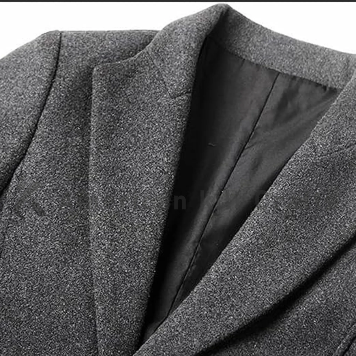 Close-up of men’s single-breasted wool trench coat showing the button-down front, structured collar, wool fabric texture and refined tailoring details.