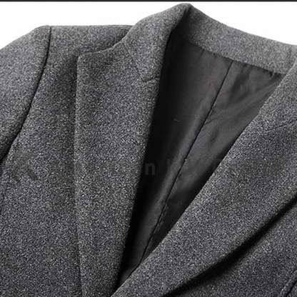 Close-up of men’s single-breasted wool trench coat showing the button-down front, structured collar, wool fabric texture and refined tailoring details.