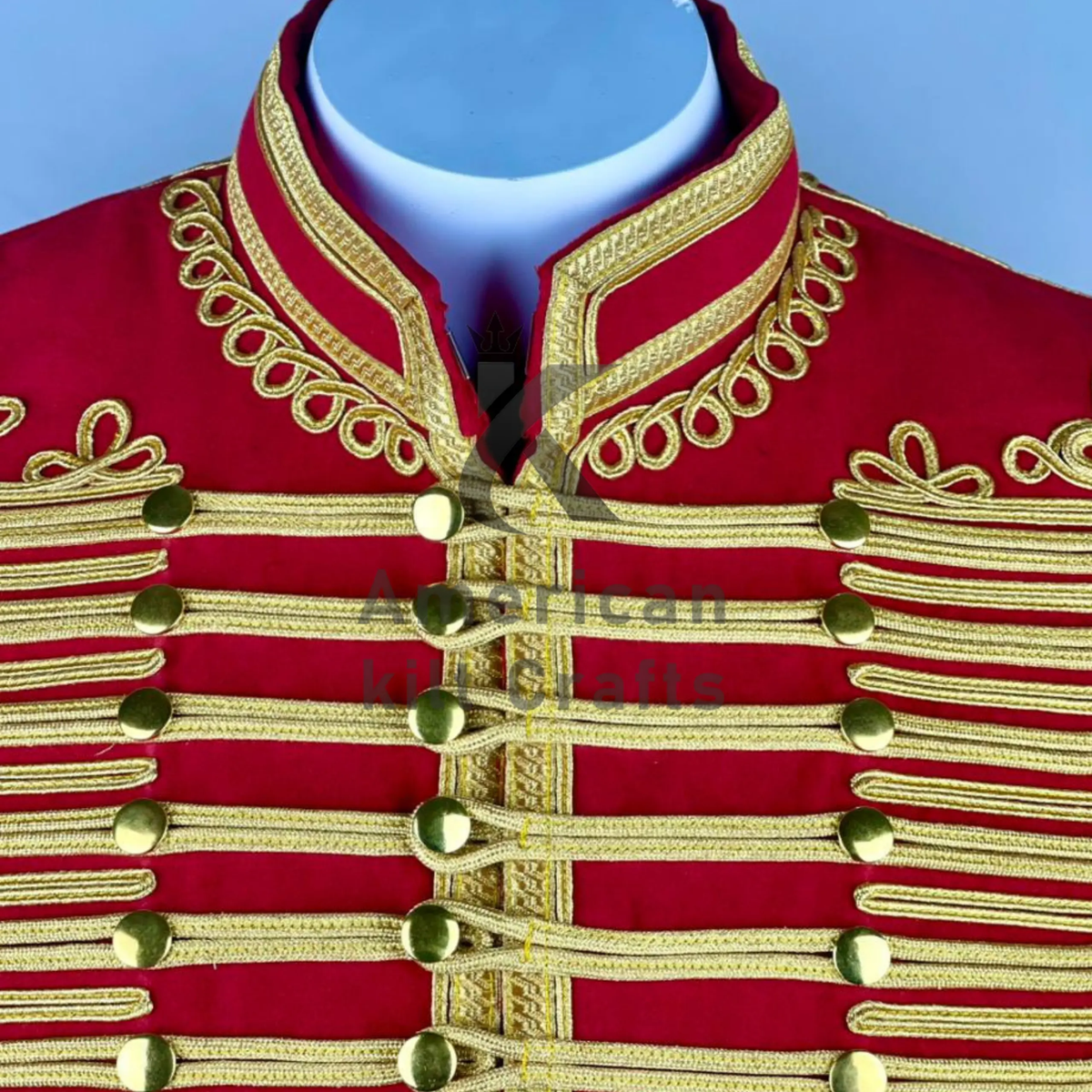 Close-up of gold braided detailing, decorative buttons, and ornate military trim on a men's red Hussar jacket.