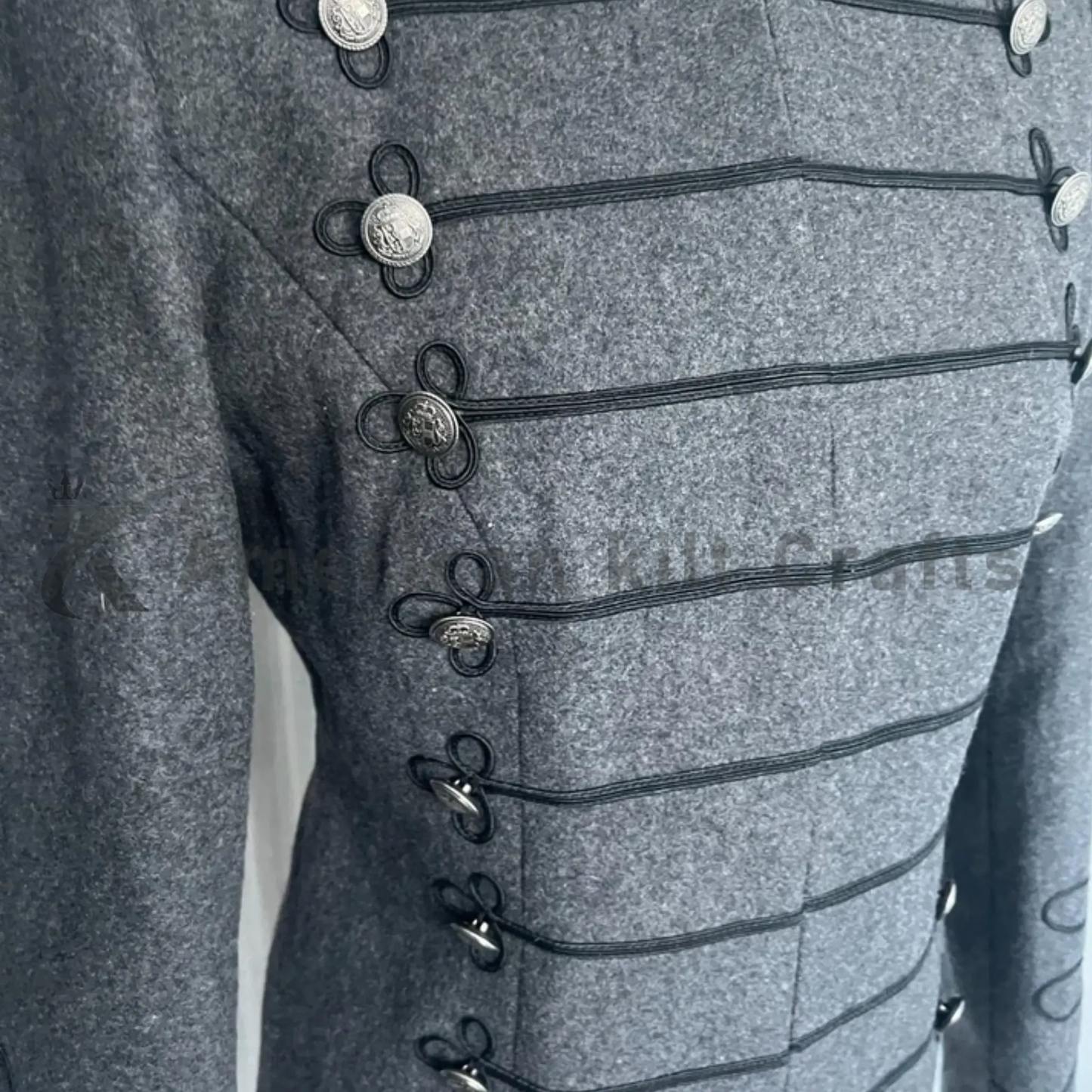 Close-up of a women’s grey Napoleon jacket displaying ornate Hussar braidwork, decorative buttons and detailed wool craftsmanship.
