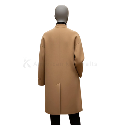 Back view of women’s camel long overcoat showing minimalist tailoring and classic winter coat silhouette.